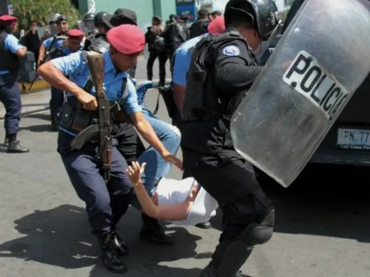 Policías arrastrando a una manifestante durante una protesta en Nicaragua